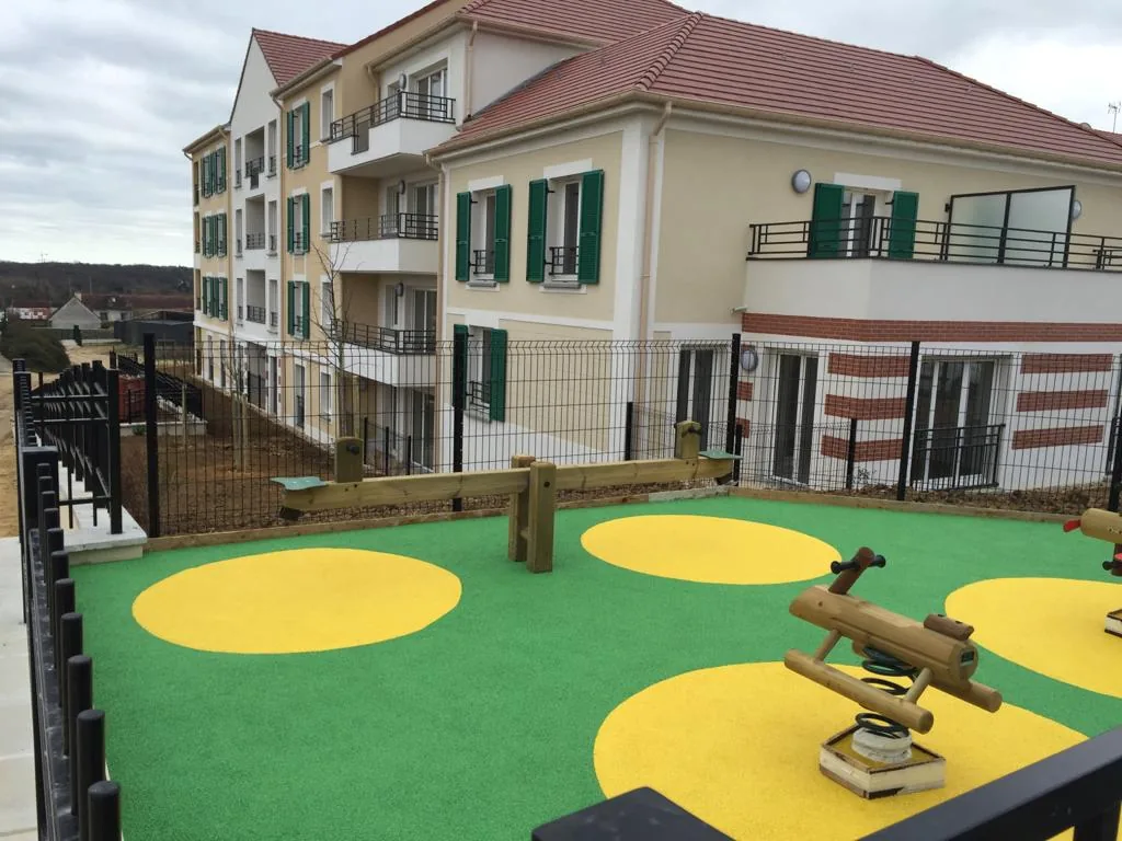 Sol EPDM amortissant vert et jaune pour aire de jeux en pied d'immeuble
